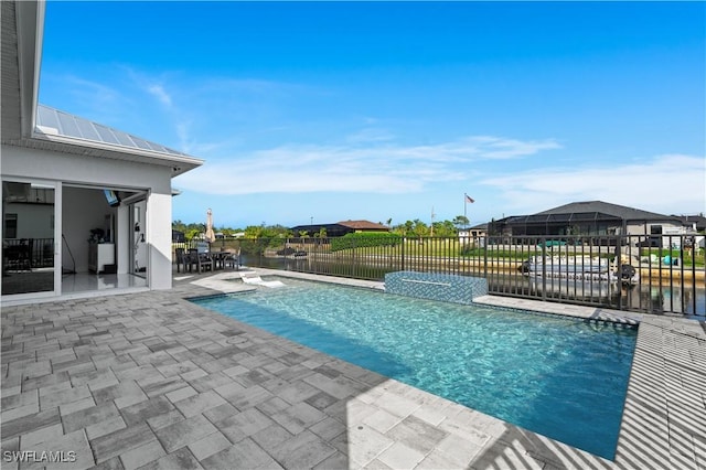 view of pool with a water view, pool water feature, and a patio