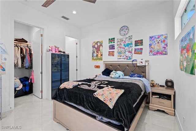 bedroom featuring a spacious closet and a closet