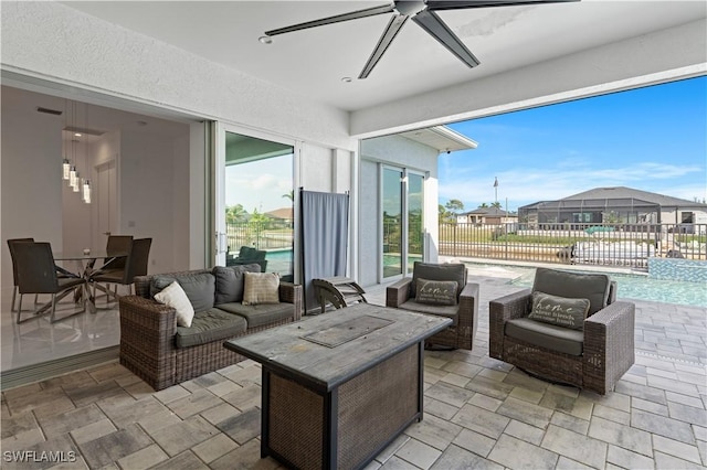 view of patio / terrace with a fenced in pool, an outdoor hangout area, and ceiling fan