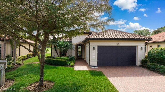 mediterranean / spanish-style home featuring a garage and a front lawn