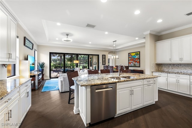 kitchen featuring dishwasher, sink, white cabinets, and a tray ceiling