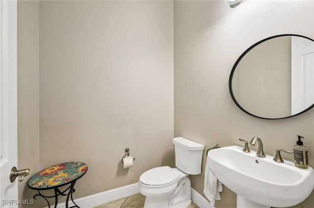 bathroom with sink, tile patterned floors, and toilet