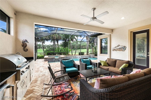 view of patio / terrace featuring exterior kitchen, an in ground hot tub, a lanai, grilling area, and an outdoor living space