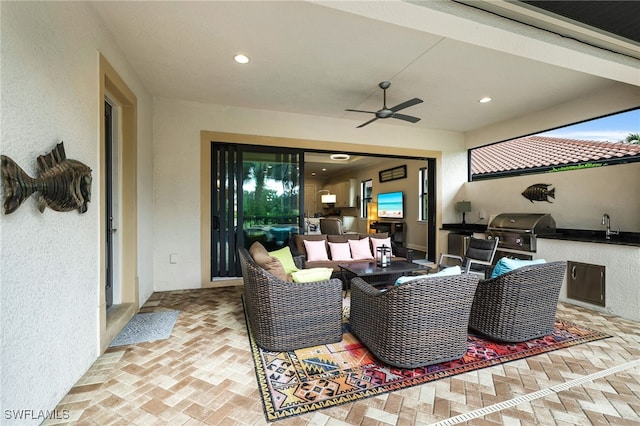 view of patio featuring outdoor lounge area, a grill, sink, exterior kitchen, and ceiling fan