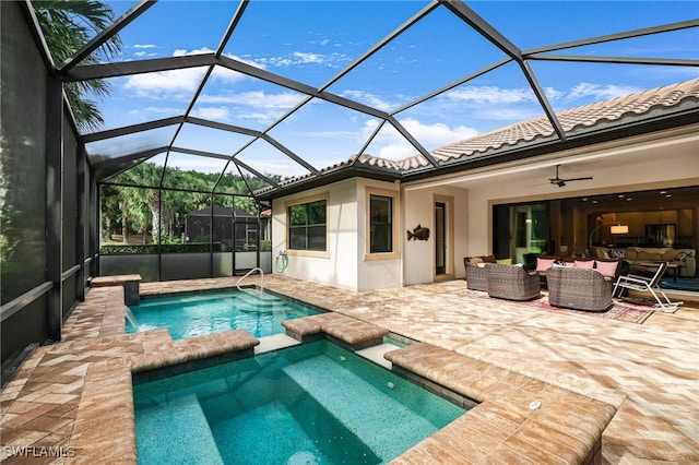 view of swimming pool featuring a patio area, a lanai, an in ground hot tub, ceiling fan, and an outdoor hangout area