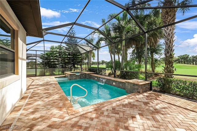 view of swimming pool featuring a patio area, pool water feature, glass enclosure, and an in ground hot tub