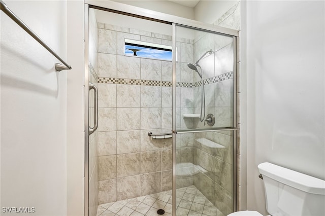 bathroom featuring walk in shower and toilet