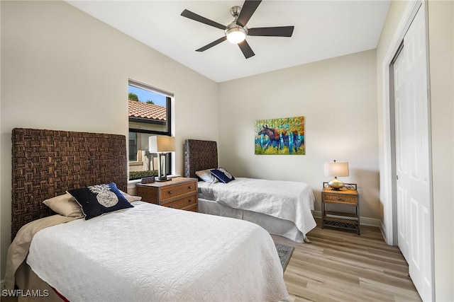 bedroom with ceiling fan, a closet, and light wood-type flooring