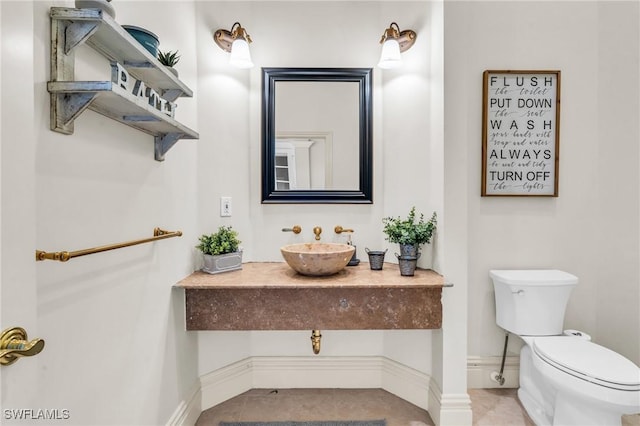 bathroom featuring tile patterned flooring, sink, and toilet