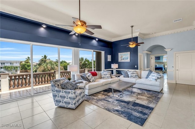 living room featuring light tile patterned floors, crown molding, and ceiling fan