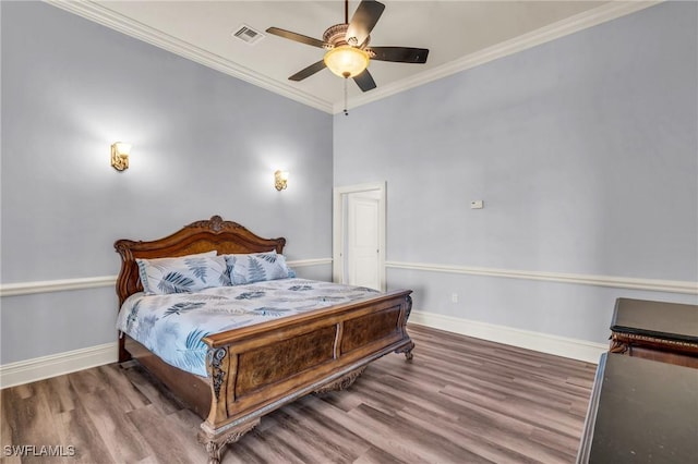 bedroom with hardwood / wood-style flooring, ceiling fan, and ornamental molding