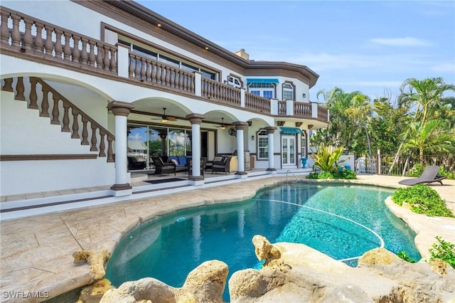 view of swimming pool with a patio and ceiling fan