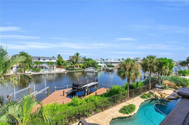 view of swimming pool featuring a water view and a boat dock