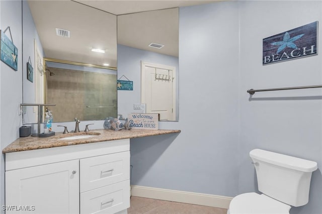 bathroom featuring vanity, toilet, and a shower with shower door