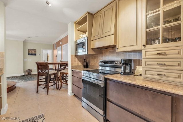 kitchen featuring tasteful backsplash, crown molding, light stone counters, light tile patterned floors, and stainless steel appliances