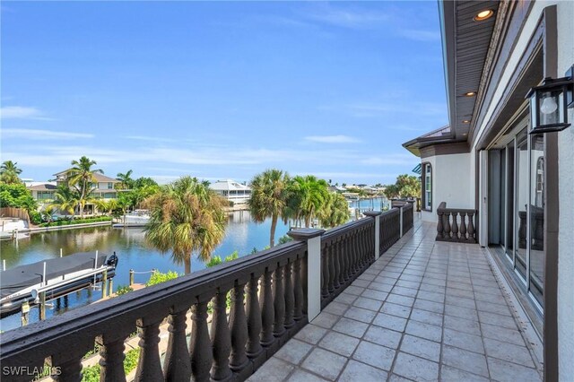 balcony featuring a water view and a dock