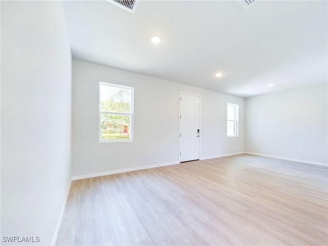 unfurnished room with light hardwood / wood-style flooring