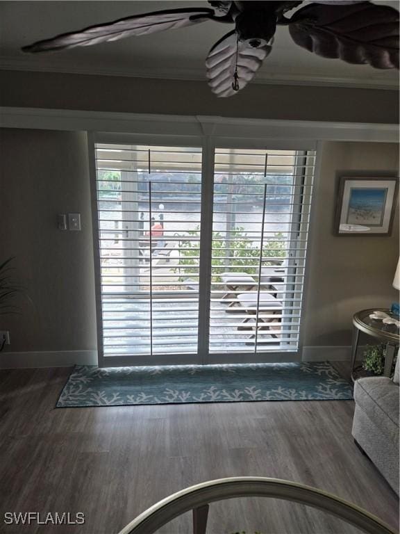 doorway to outside featuring dark hardwood / wood-style flooring, crown molding, and plenty of natural light