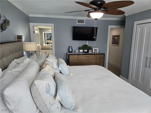 bedroom with ornamental molding, ceiling fan, and ensuite bath