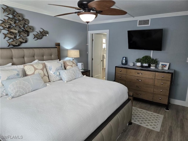 bedroom featuring dark hardwood / wood-style flooring, crown molding, ensuite bath, and ceiling fan