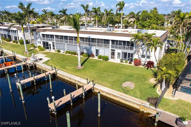 dock area featuring a water view and a lawn