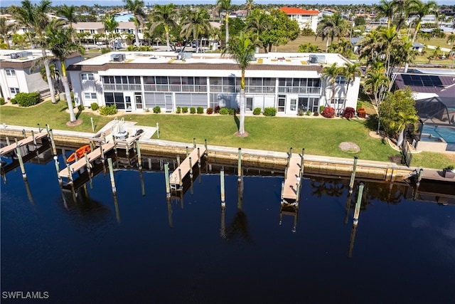 rear view of property featuring a water view and a yard