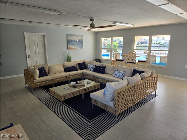 living room featuring ceiling fan and wood-type flooring