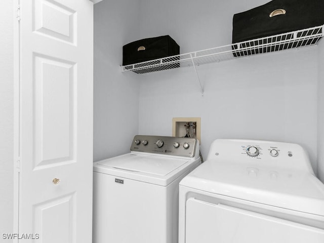 washroom featuring washer and clothes dryer