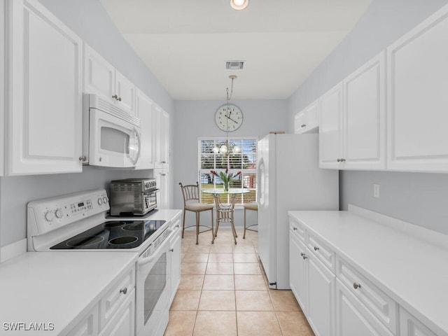 kitchen with pendant lighting, light tile patterned floors, white appliances, white cabinetry, and an inviting chandelier