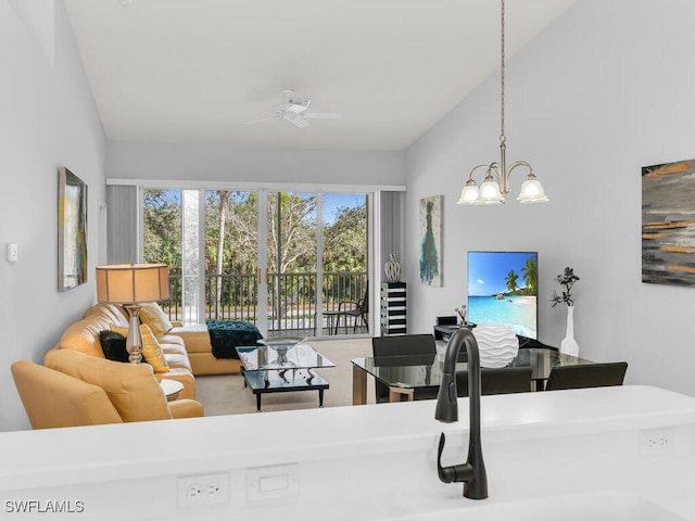 interior space featuring vaulted ceiling and ceiling fan with notable chandelier