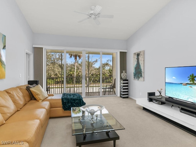 living room with ceiling fan, light colored carpet, lofted ceiling, and a wealth of natural light