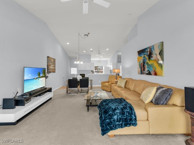 carpeted living room featuring ceiling fan with notable chandelier