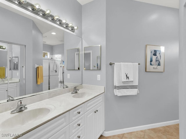 bathroom with an enclosed shower, vanity, and tile patterned floors