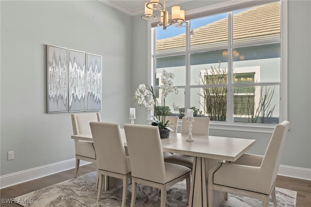 dining area featuring a notable chandelier, hardwood / wood-style flooring, and ornamental molding