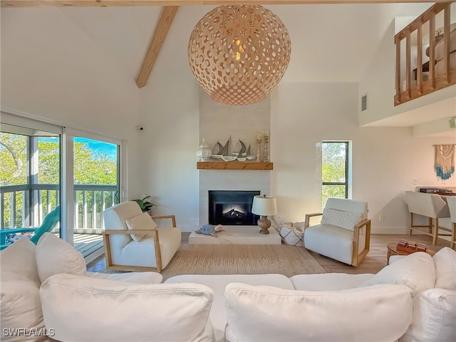 living room featuring a towering ceiling, wood-type flooring, and beamed ceiling