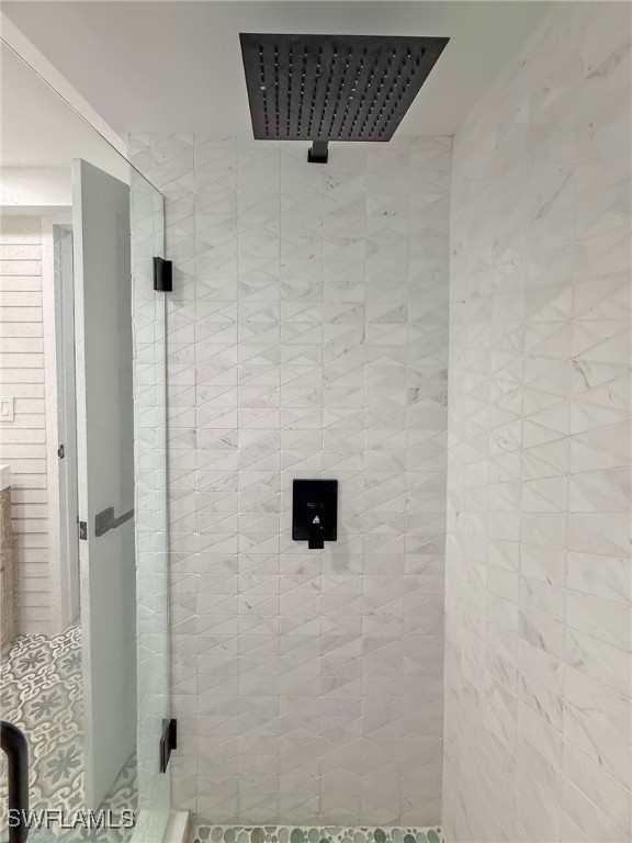 bathroom featuring a shower with shower door