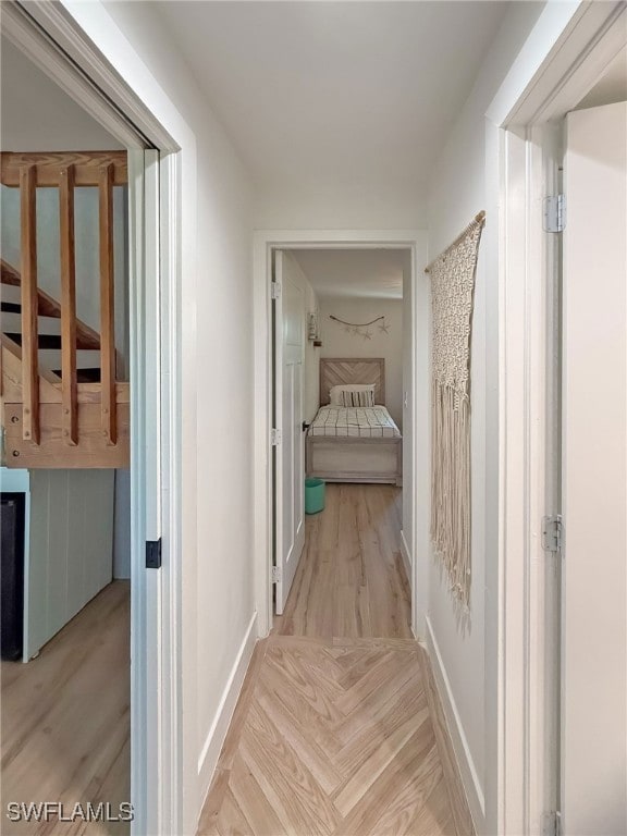 corridor with light hardwood / wood-style flooring