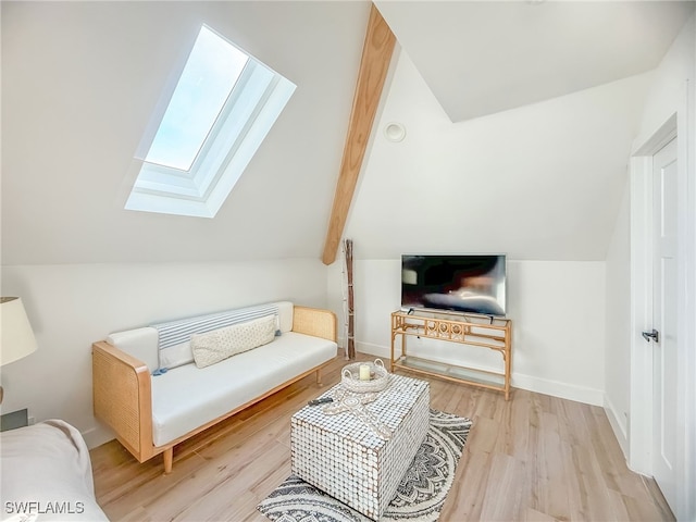 living room featuring lofted ceiling with skylight and light hardwood / wood-style floors