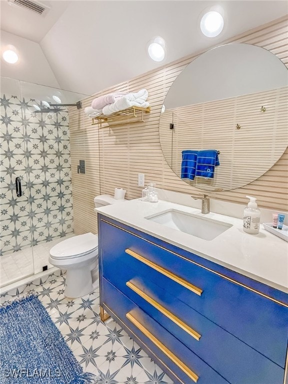 bathroom with an enclosed shower, vanity, vaulted ceiling, and toilet