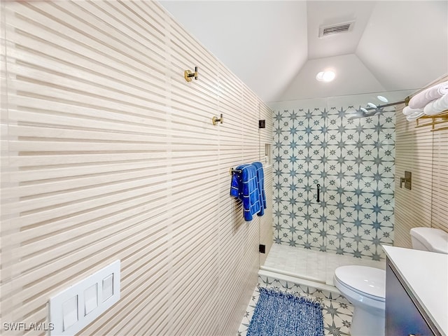 bathroom featuring vanity, vaulted ceiling, tile patterned floors, toilet, and walk in shower