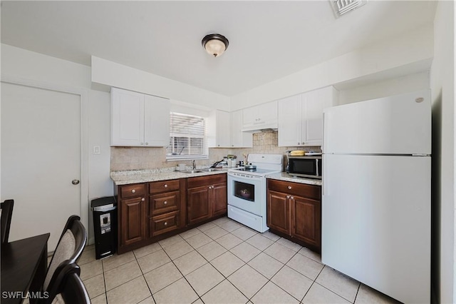 kitchen featuring sink, white cabinets, decorative backsplash, dark brown cabinetry, and white appliances