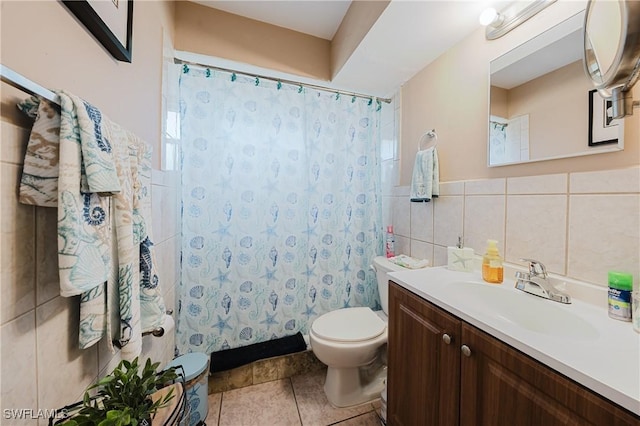 bathroom with tile patterned flooring, vanity, tile walls, and toilet