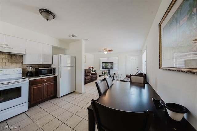 kitchen featuring white appliances, white cabinetry, dark brown cabinetry, light tile patterned flooring, and decorative backsplash