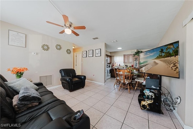 living room featuring light tile patterned floors and ceiling fan