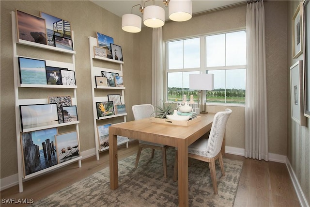 dining area with wood finished floors and baseboards