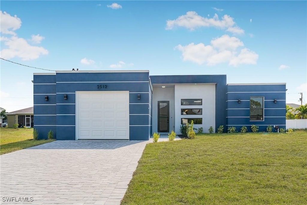 contemporary home with a garage and a front lawn