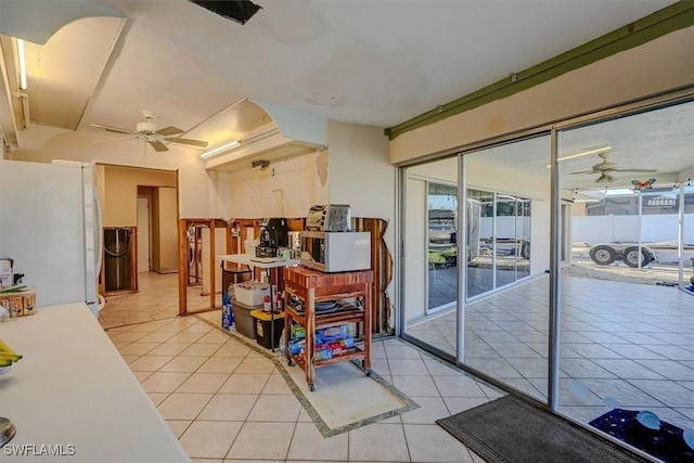 tiled dining room with ceiling fan