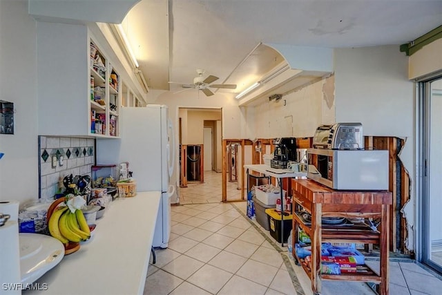 kitchen with white refrigerator, light tile patterned floors, and ceiling fan