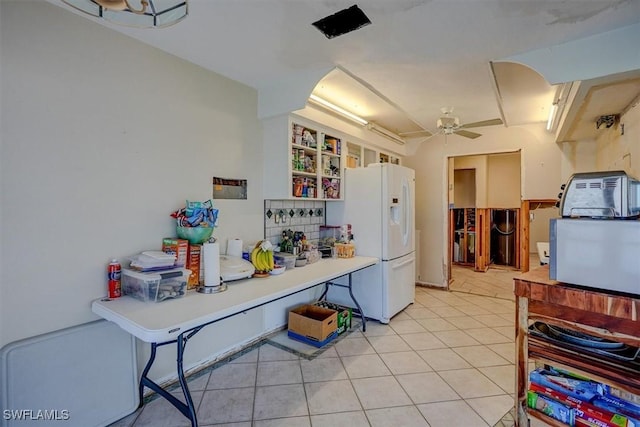 kitchen with ceiling fan, white refrigerator with ice dispenser, and light tile patterned floors