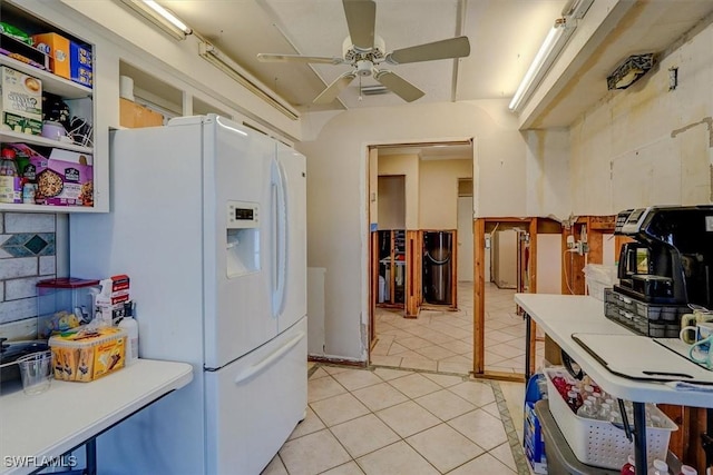 kitchen featuring light tile patterned flooring, ceiling fan, and white fridge with ice dispenser